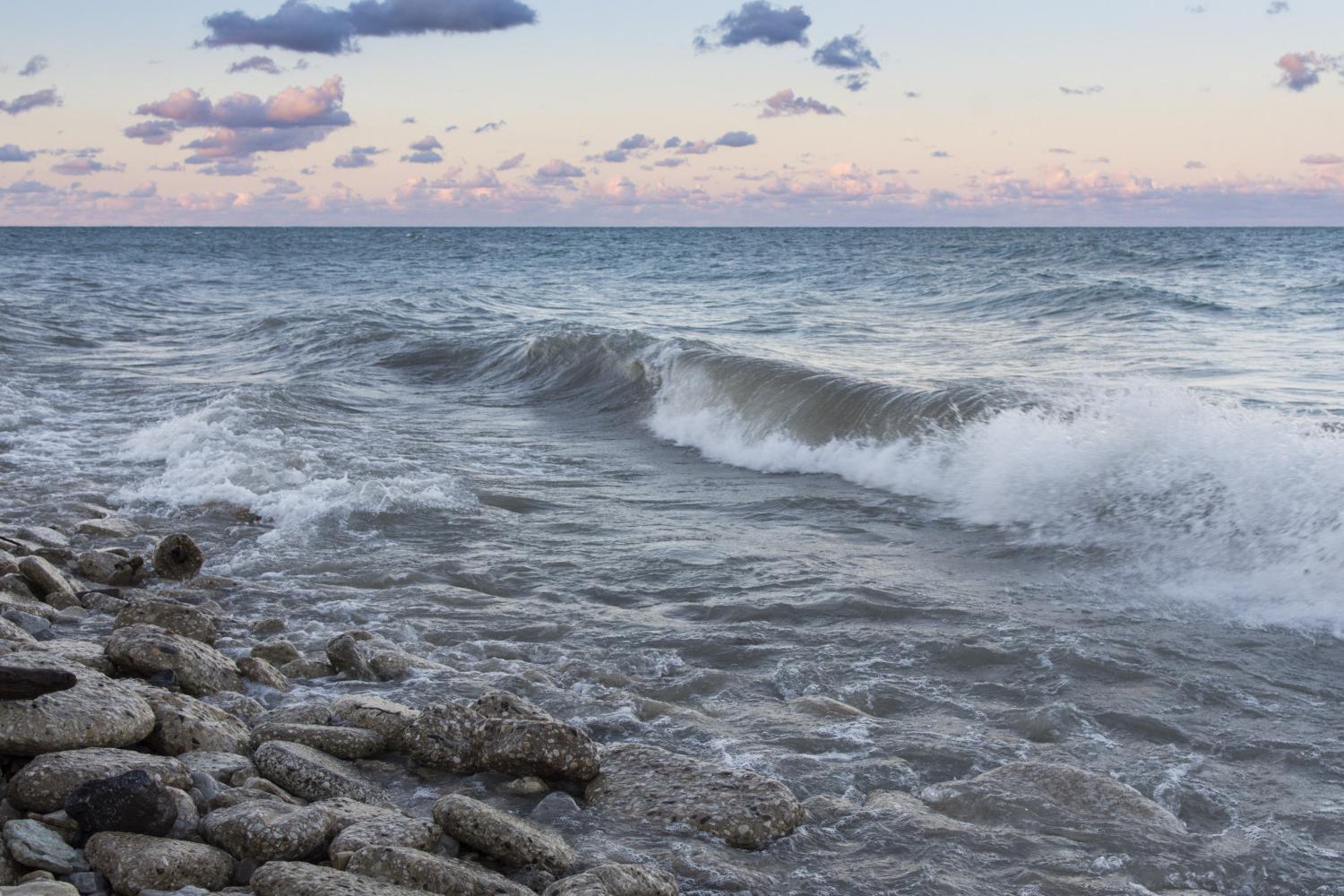 The sun rises over Lake Michigan on the <a href='http://bgu.shuguangprinting.com'>BETVLCTOR伟德登录</a> campus.